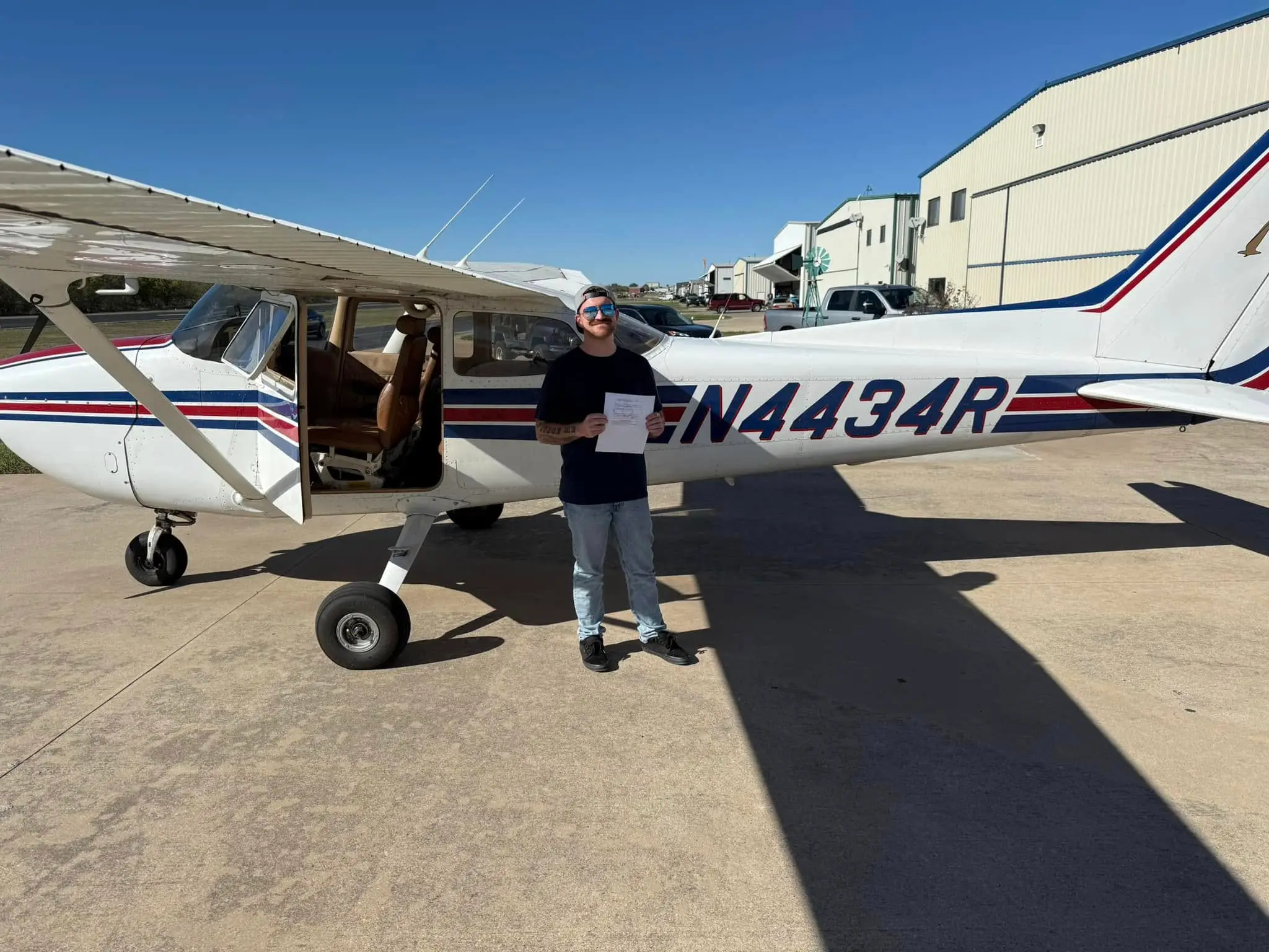 Confident student pilot in cockpit during flight lesson at Bird Dog Flight Services in Fort Worth