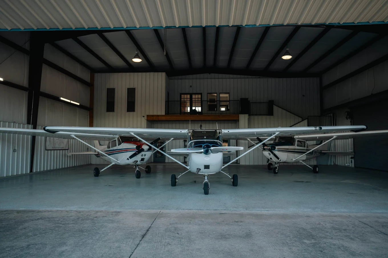 Bird Dog Flight Services training aircraft fleet inside hangar at Hicks Airfield
